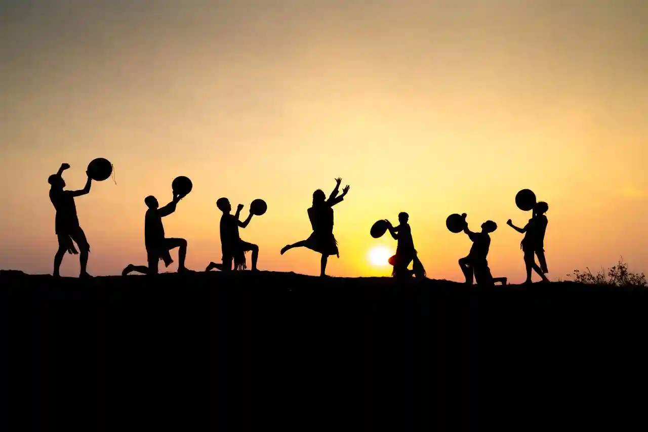Participants dancing at sunrise in dramatic drama scene